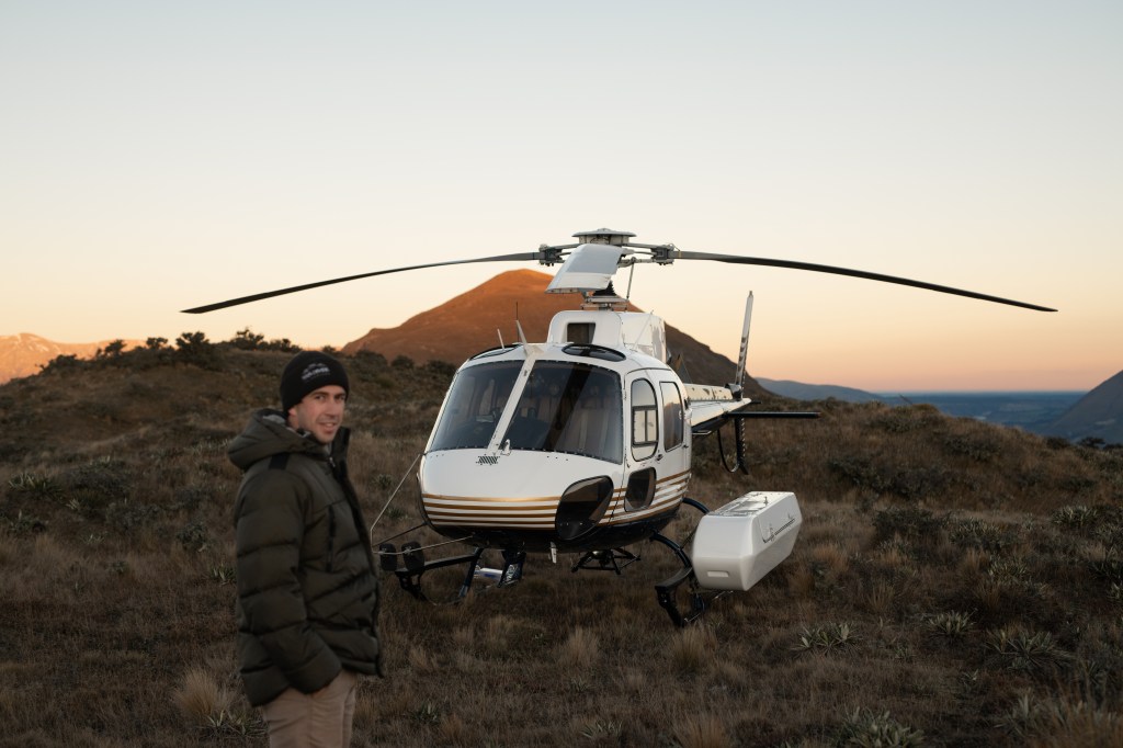 our pilot standing next to the helicopter