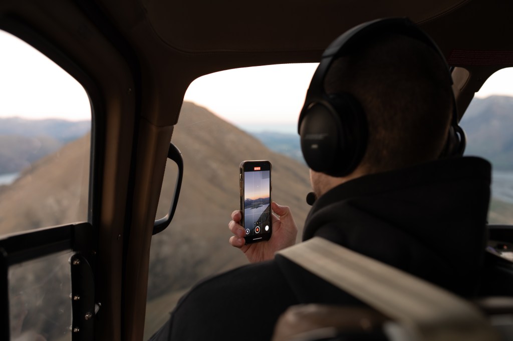 person taking photos from the helicopter, scenic flight photos